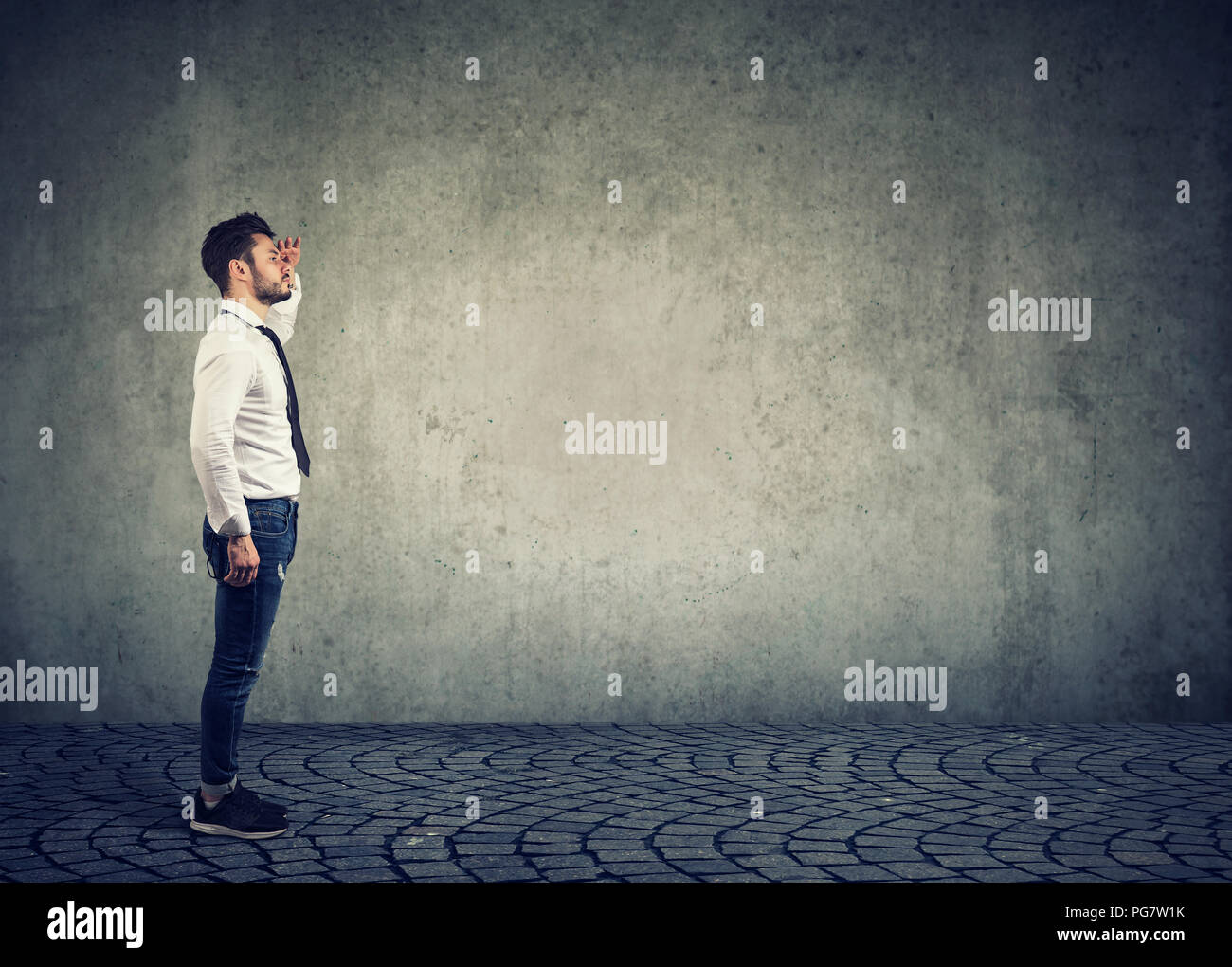 Seitenansicht des stilvollen Geschäftsmann auf der Suche nach Planung und Prognose auf grauem Hintergrund Stockfoto