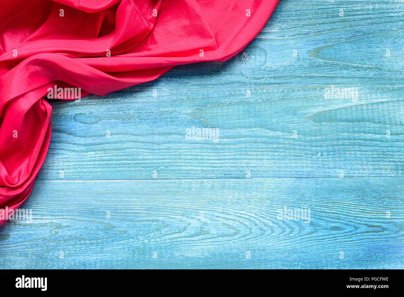 Rotes Tuch auf einem blauen Holztisch. Kopieren Sie Raum und Ansicht von oben. Stockfoto