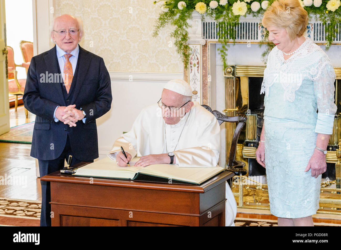 Dublin, Irland. 25/08/2018 - Papst Franziskus zeichen Buch des Besuchers als er nach Irland begrüßt wird durch die irische Präsidentin, Michael D. Higgins, und seine Frau Sabina, bei den Aras eine Uachtarain (Präsident des offiziellen Wohnsitz). Stockfoto