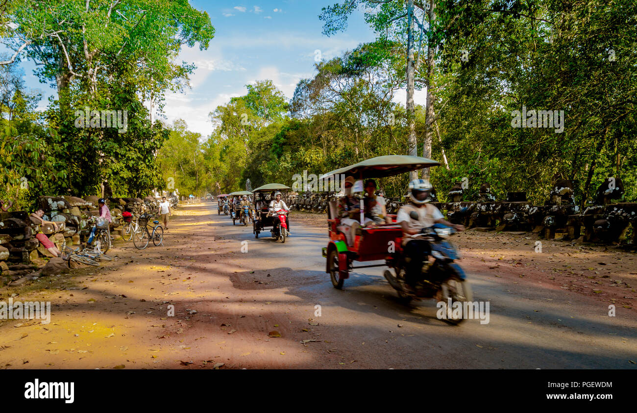 Eine Linie der Tuk Tuks unten kommen, eine Landstraße Tourist, zum Angkor Tempel Stockfoto