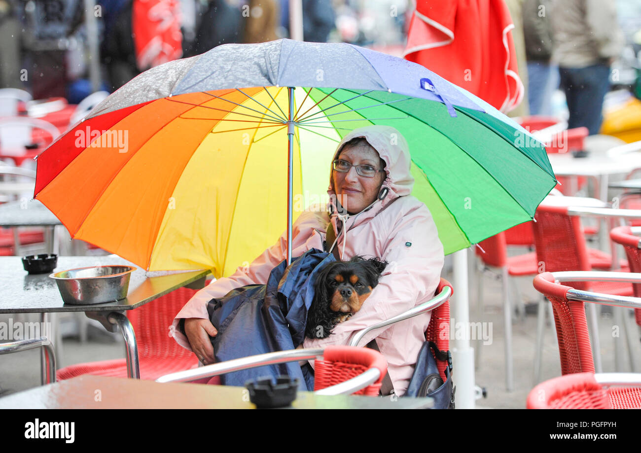 Brighton UK 26. August 2018 - Dieser Hund und Besitzer bleiben trocken auf Brighton Seafront in der Wind und der Regen da schlechtes Wetter fegt über der Südküste heute, aber die Prognose ist für es für August Bank Holiday Montag: Simon Dack/Alamy Leben Nachrichten verbessern Stockfoto