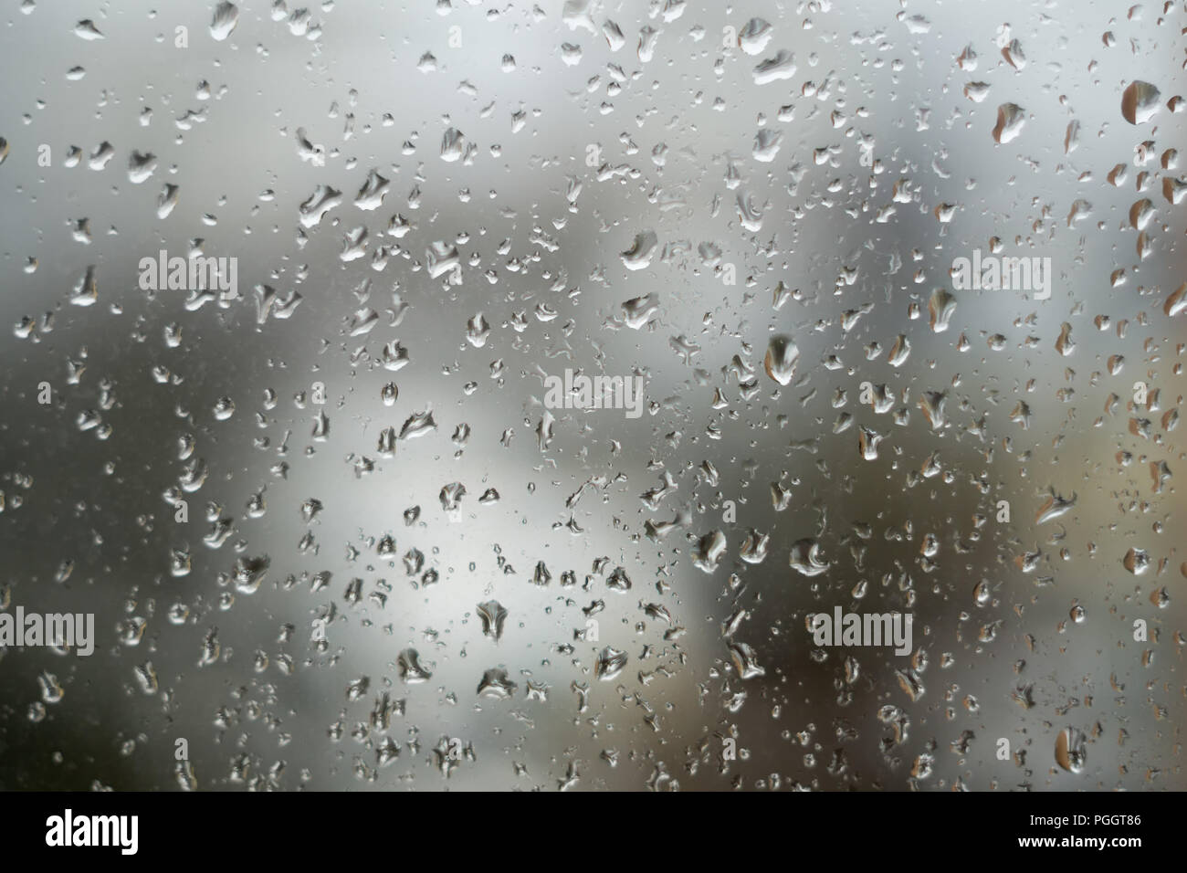 Regentropfen auf Fenster, regnerischen Wetter. Abstrakte grauer Hintergrund, Textur der Regen fällt auf Glas Stockfoto