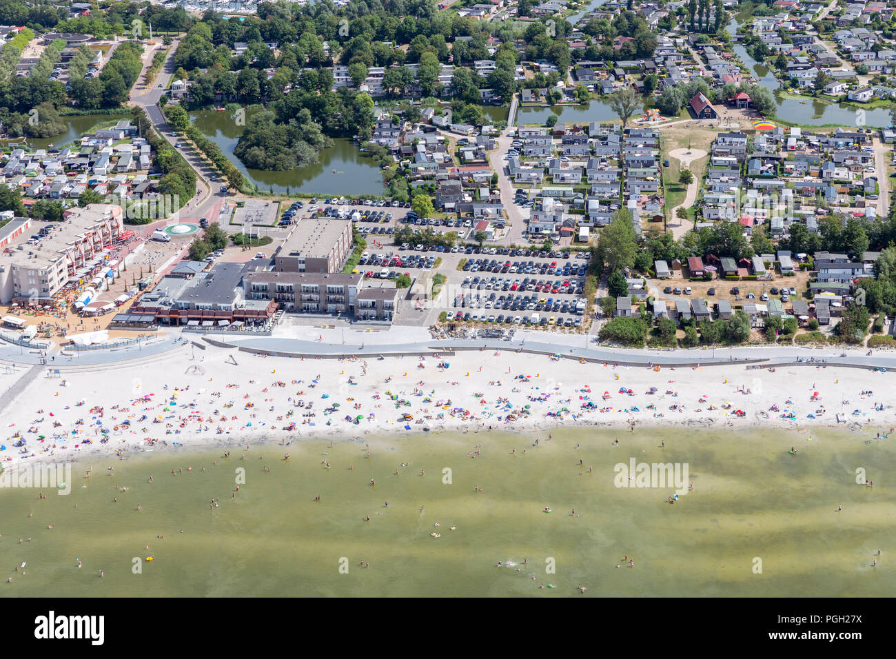 Luftaufnahme niederländische Dorf Makkum mit Strand und Schwimmen Menschen Stockfoto