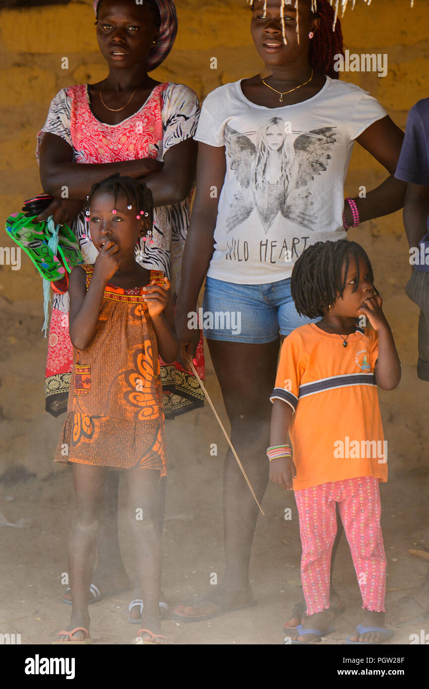 ORANGO INSEL, GUINEA BISSAU - Mai 3, 2017: Unbekannter lokaler kleines Mädchen mit Zöpfen steckt ihren Finger in den Mund, in der Etigoca Dorf. Menschen Stockfoto