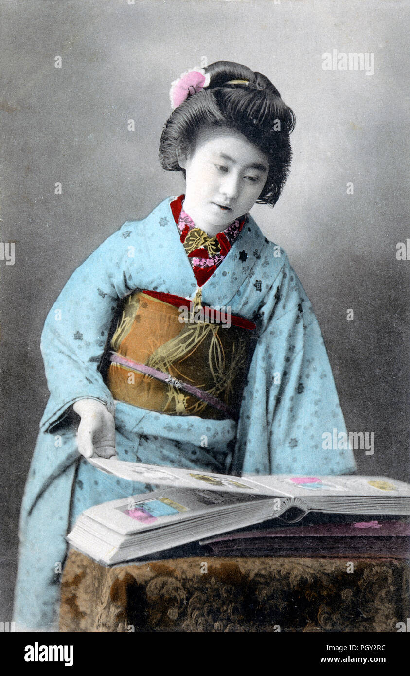 [1910s Japan - Japanische Frau im Kimono] - junge japanische Frau im Kimono und traditionelle Frisur Fotos oder Postkarten in einem Album suchen. 20. jahrhundert alte Ansichtskarte. Stockfoto