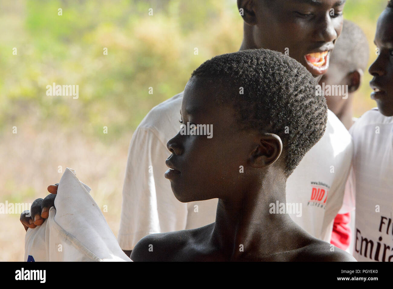 ORANGO INSEL, GUINEA BISSAU - Mai 3, 2017: Unbekannter lokaler Junge hält sein Shirt nach einer physischen Kultur Lektion auf der Orange Insel Stockfoto