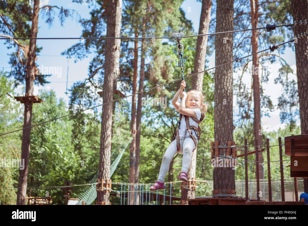 Kleines Mädchen mit Aktivität in einem klettern Adventure Park. Stockfoto