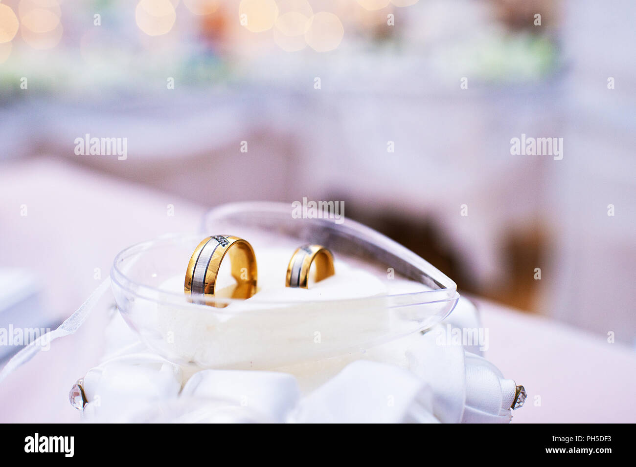 Zwei Trauringe im Glas Herz Stockfoto