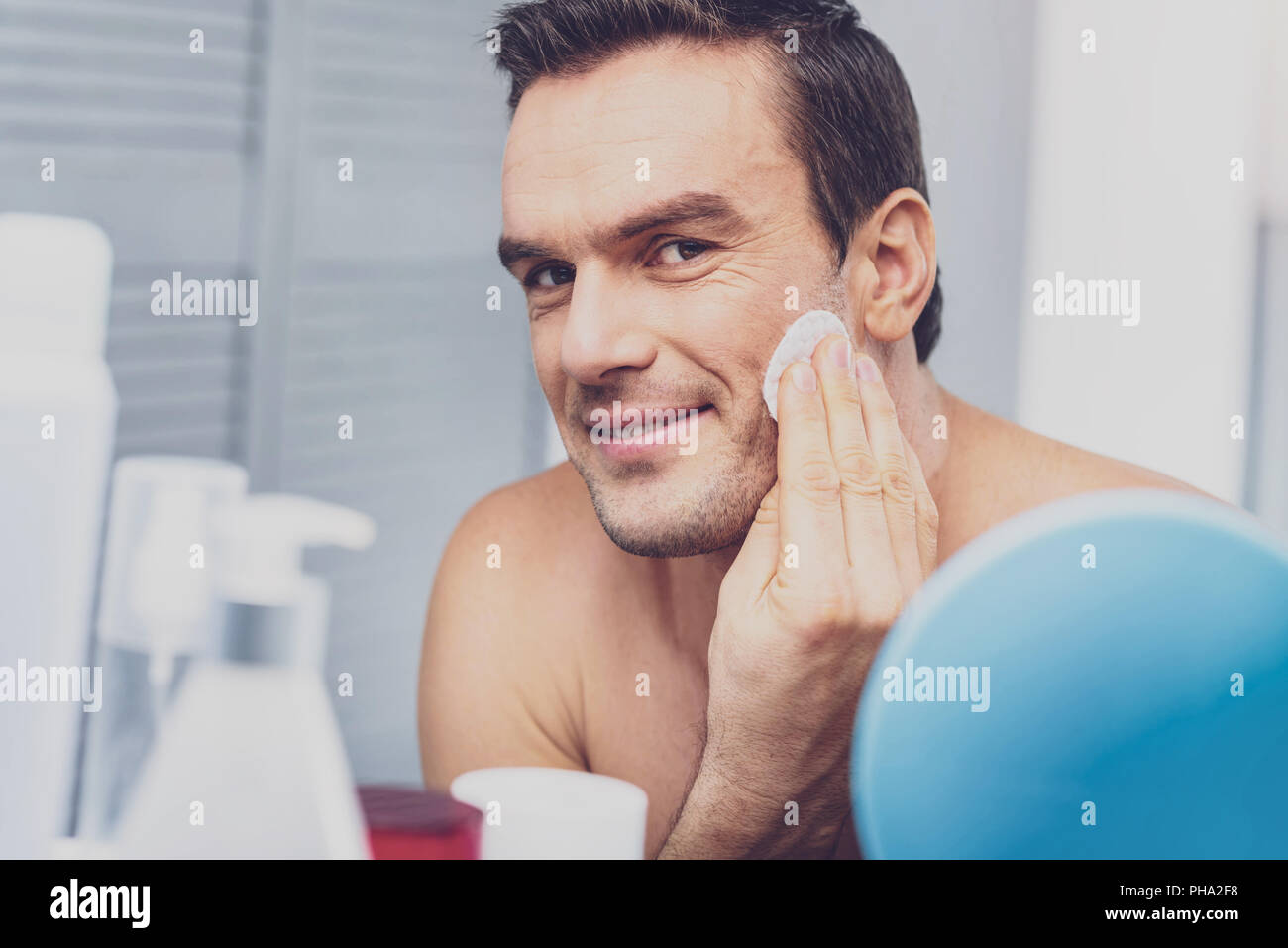 Dunkelhaarige Mann im Spiegel suchen Stockfoto