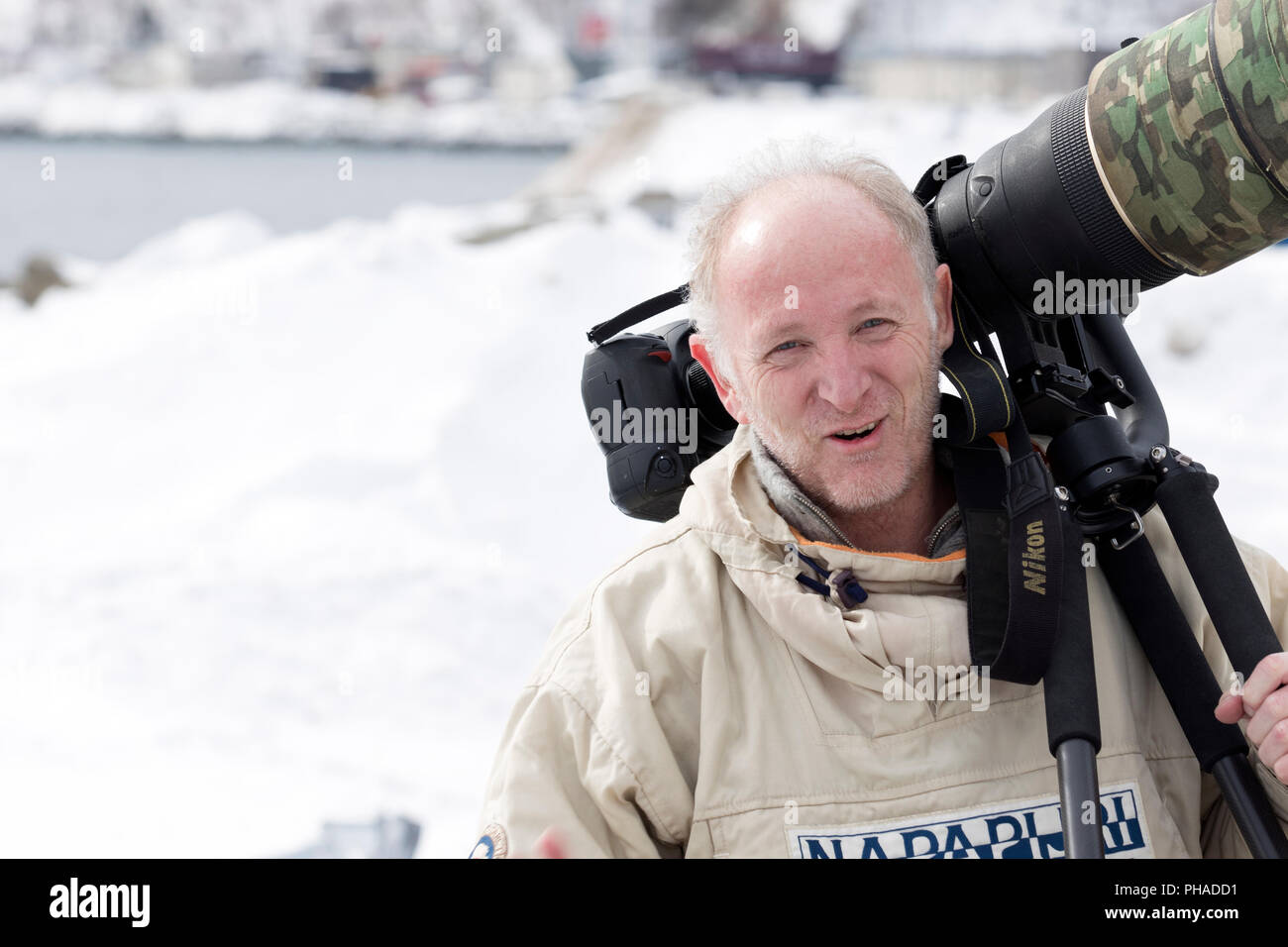 Fotograf mit einem großen Objektiv (600 mm) im Schnee Stockfoto