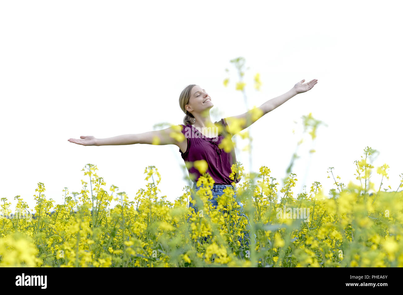 Frau Jubel in Raps Feld Stockfoto