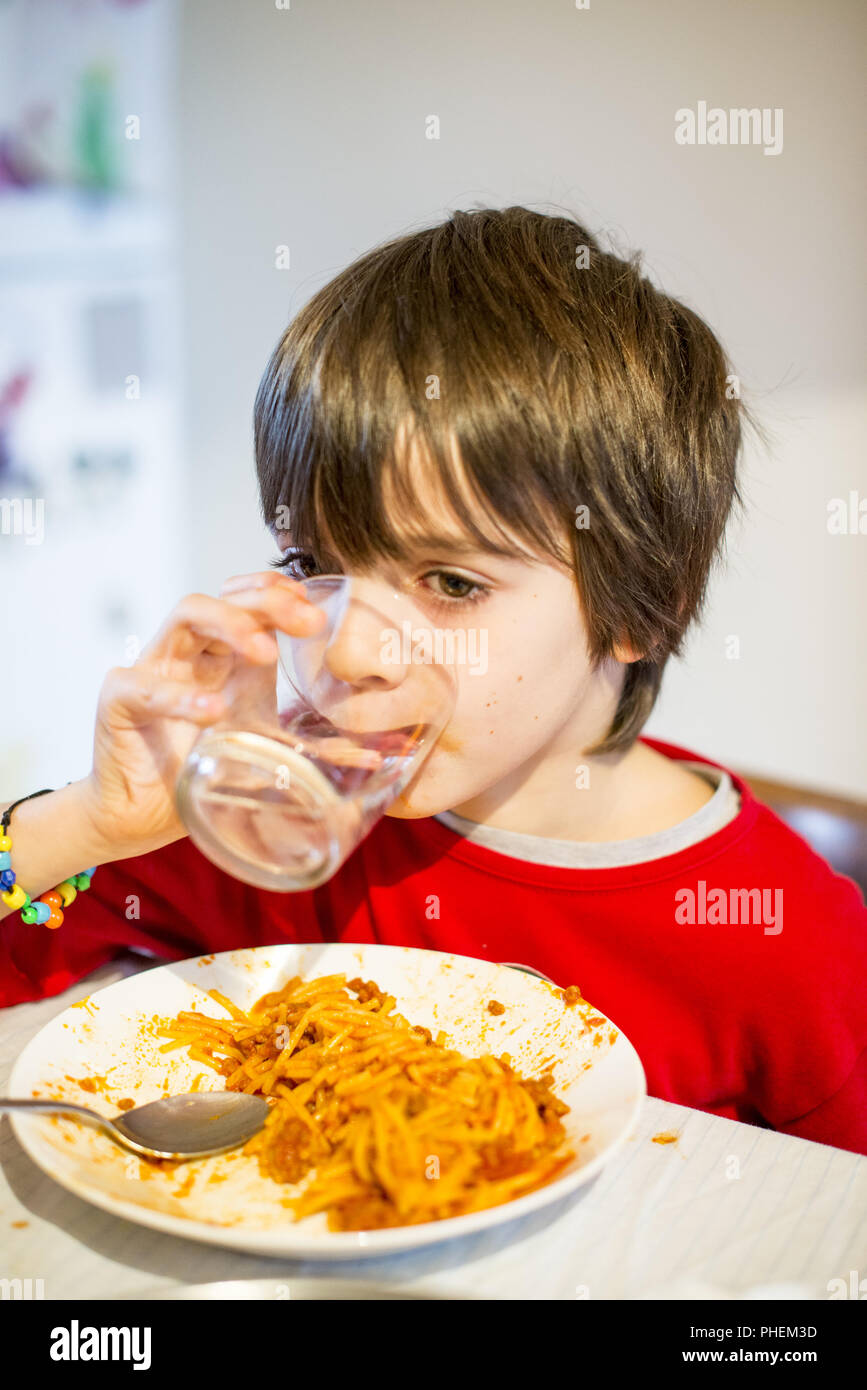 Kinder Trinkwasser und Essen spaghetti Stockfoto