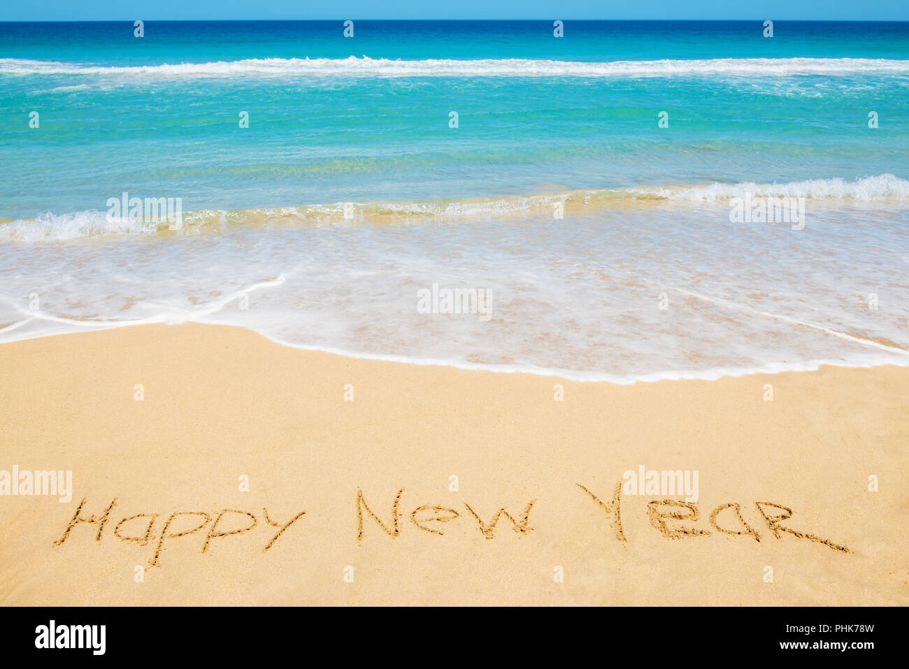 Frohes Neues Jahr Nachricht am Strand Stockfoto