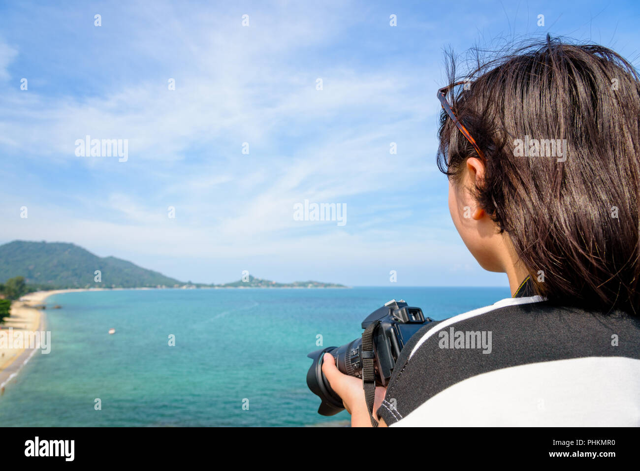 Junges Mädchen hält eine DSLR-Kamera auf hohe und schöne Natur Landschaft des blauen Meer am Strand Lamai höhe Aussichtspunkt im Sommer Reisen bei Ko Stockfoto
