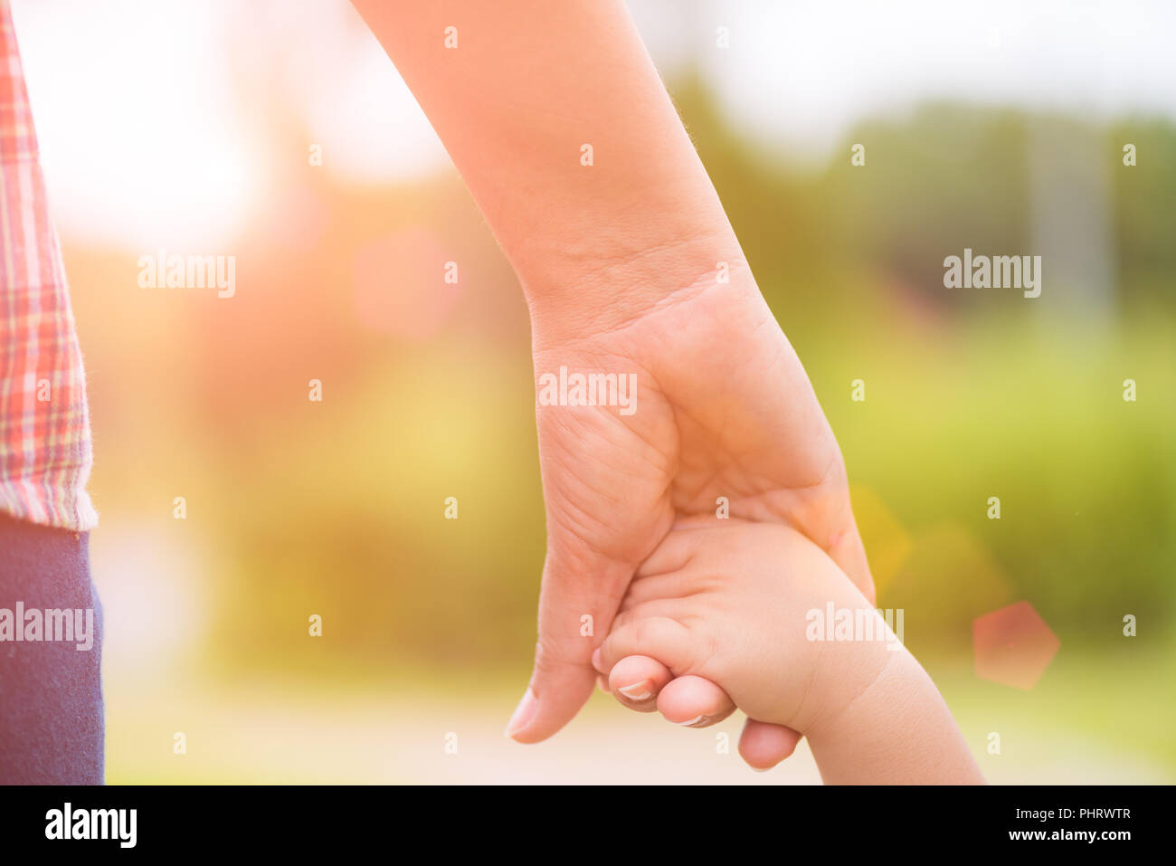 Nahaufnahme der Mutter an der Hand eines Kindes. Familie und Muttertag Konzept. Stockfoto