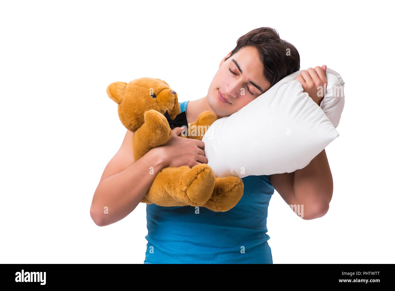 Junger Mann mit Kissen auf weißem Hintergrund Stockfoto