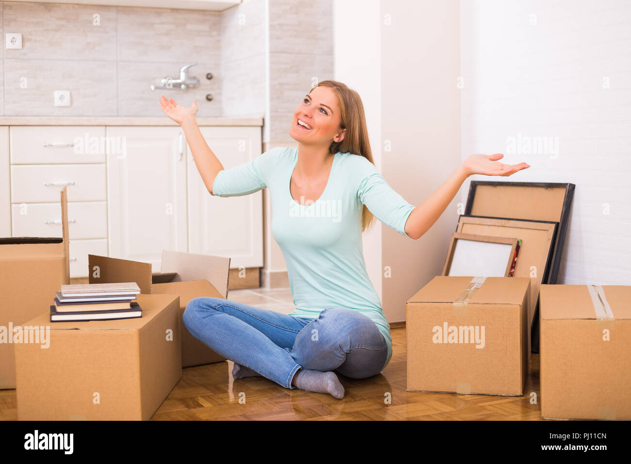 Glückliche Frau sich in die neue Wohnung. Stockfoto