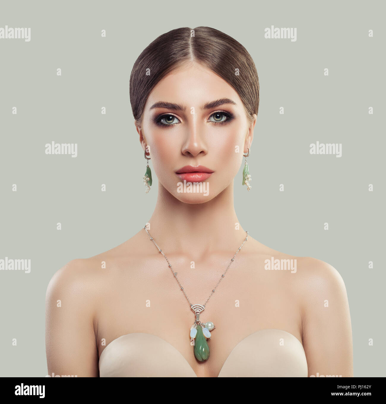 Perfekte Frau mit Modeschmuck portrait. Schmuck für die Frau, die Halskette  und Ohrringe mit Perlen und grüne Steine Stockfotografie - Alamy