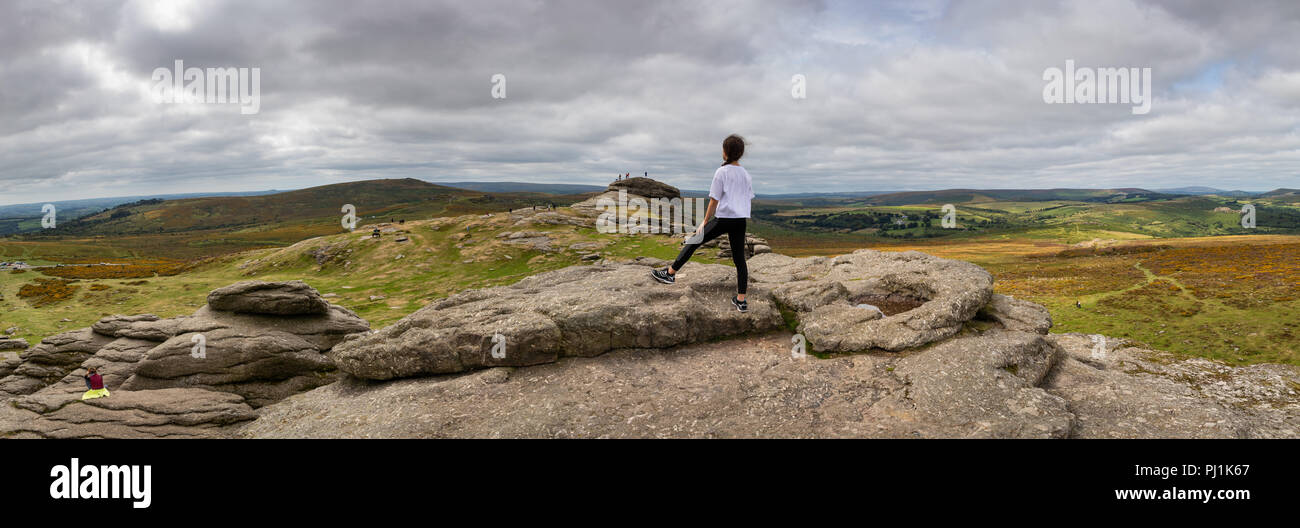 Mädchen genießt die Aussicht auf Haytor in Dartmoor, Großbritannien Stockfoto