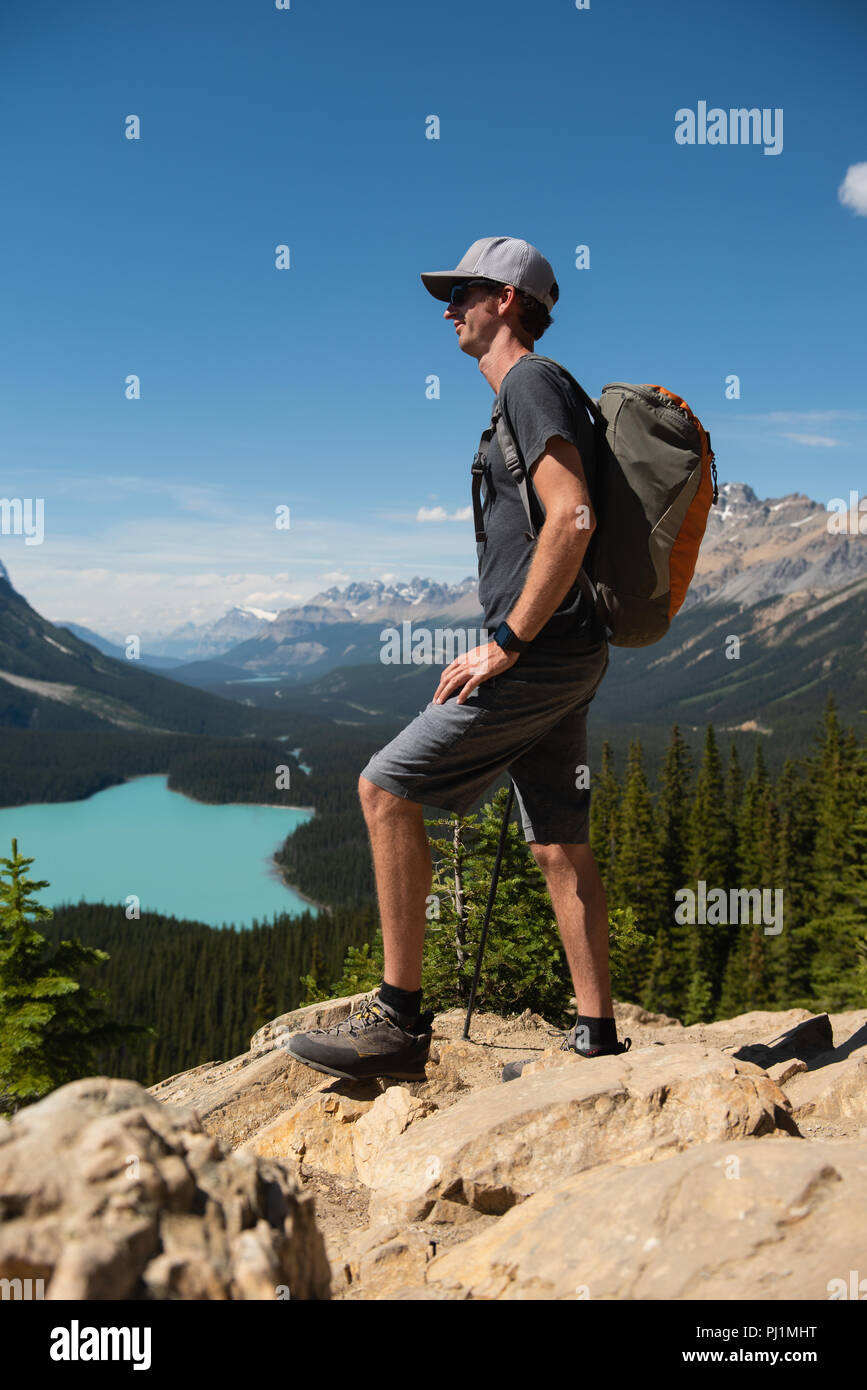 Junger Mann auf einem Felsen stehend Stockfoto