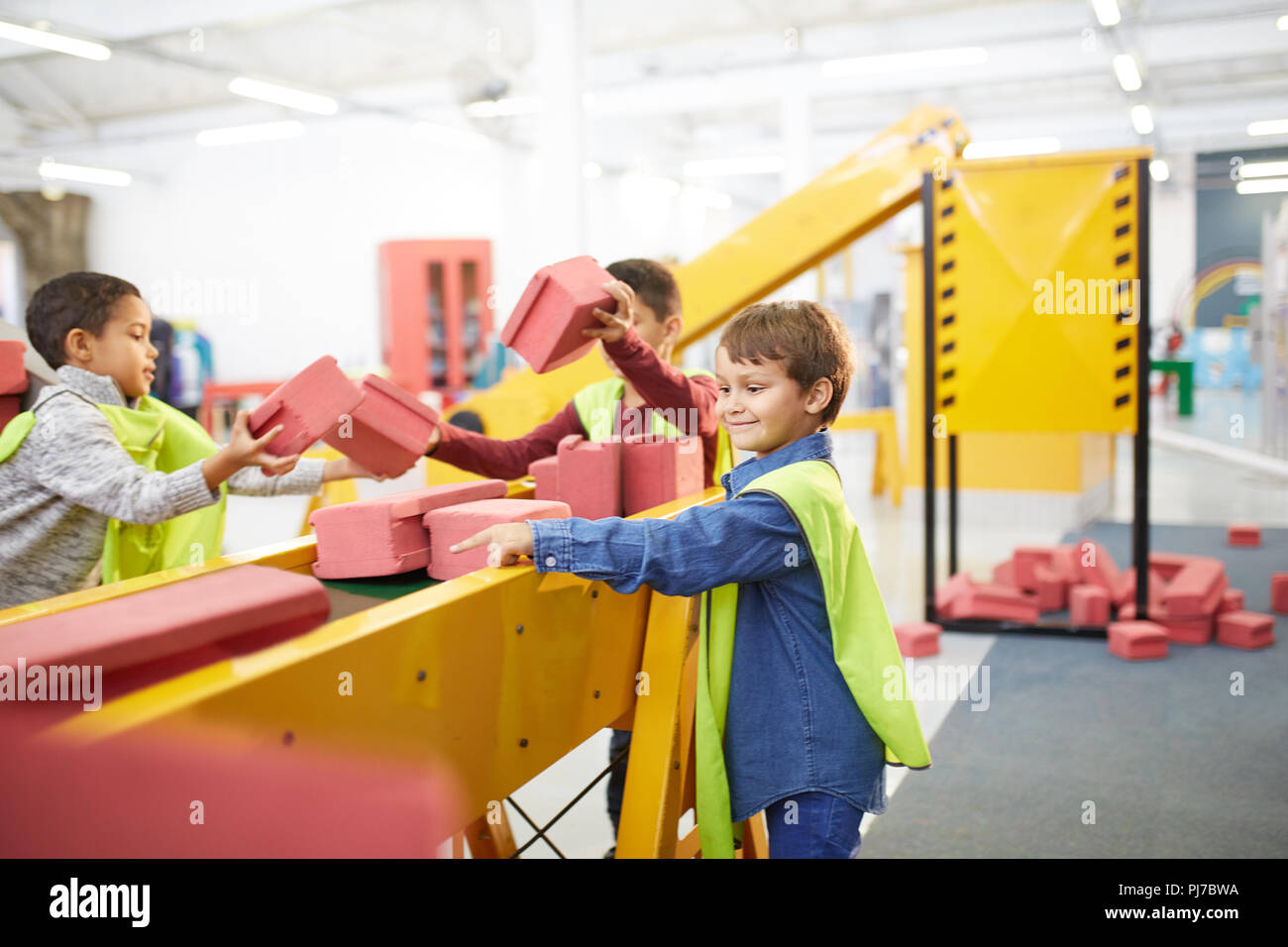 Kinder spielen mit Spielzeug Steine auf der interaktiven Konstruktion weisen im Science Center Stockfoto
