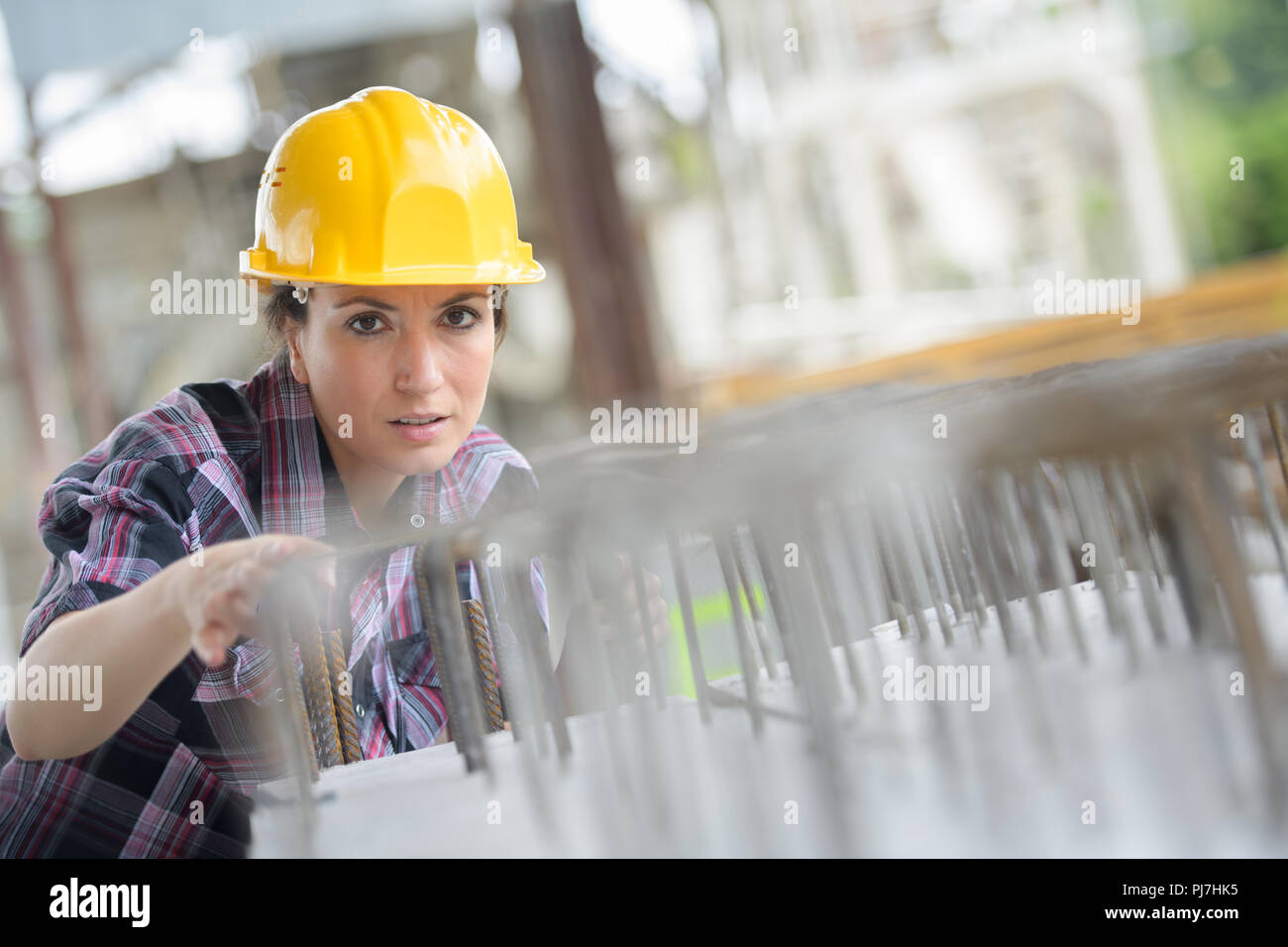 Weibliche Bauarbeiter installieren verbindliche Stahldrähte Stockfoto