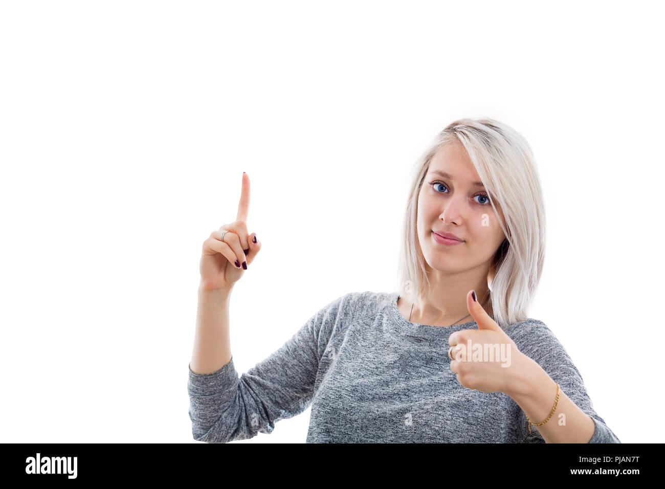 Begeisterte junge Frau Daumen oben Geste mit einer Hand und Zeigefinger oben mit einem anderen. Stockfoto
