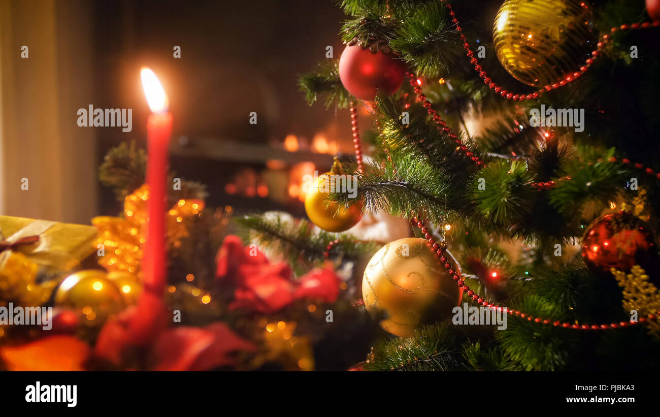 Perfektes Bild für Winterurlaub und Feiern mit Weihnachtsbaum gegen Kamin und Kerzen Stockfoto
