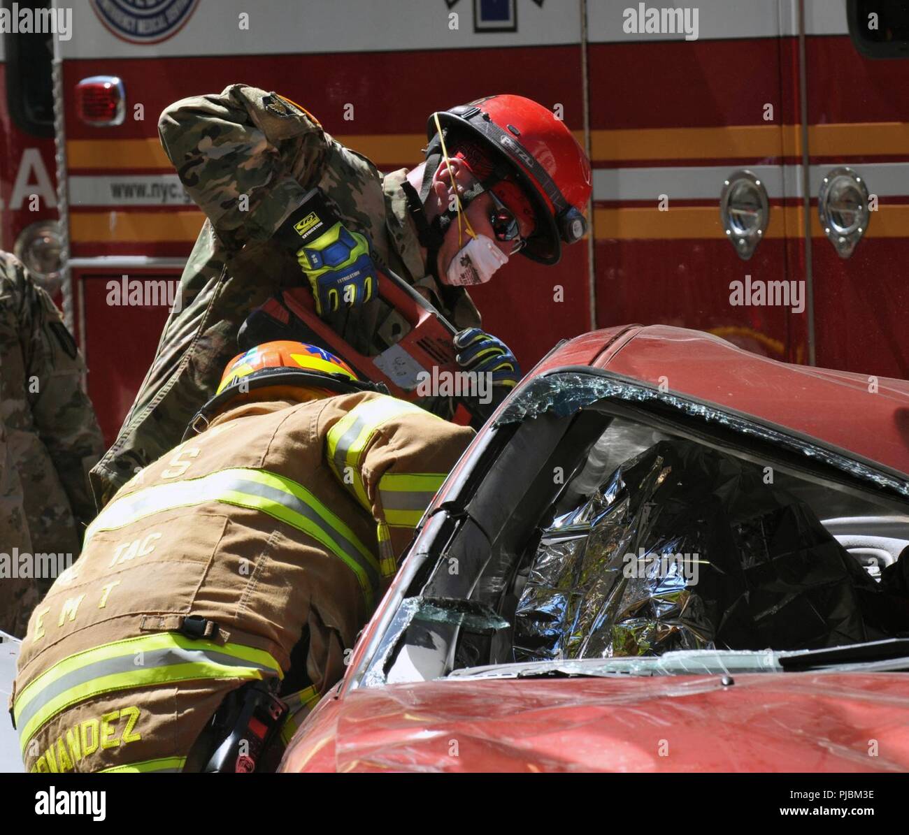 U.S. Army Reserve SPC. Corey Coffua mit der 468Th Engineer Detachment, 368 Techniker Bataillon, 302d Manöver Verbesserung Brigade, 412 Theater Ingenieur Befehl, in Danvers, Massachusetts, und Edwin Hernandez, Rettungssanitäter/Kursleiter Haz-Mat Operationen, Feuerwehr der Stadt New York (FDNY) Team während eines aus verunfallten Fahrzeugen im New York City der chemischen, biologischen, radiologischen und nuklearen (CBRN) Gemeinsame Ausbildung Übung (JTE) am Times Square Church in New York City, New York, 10. Juli 2018. Die New York City Feuerwehr FDNY mit US-Armee Nord Stockfoto