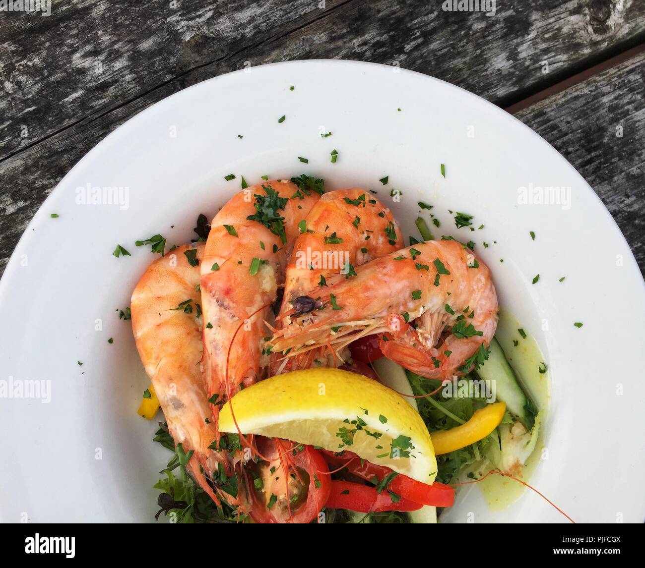 Auf der Suche nach unten von oben auf eine Fischplatte mit frischen Garnelen, Salat und Beilagen in einem gesunden Mittagessen Zeit Mahlzeit Stockfoto