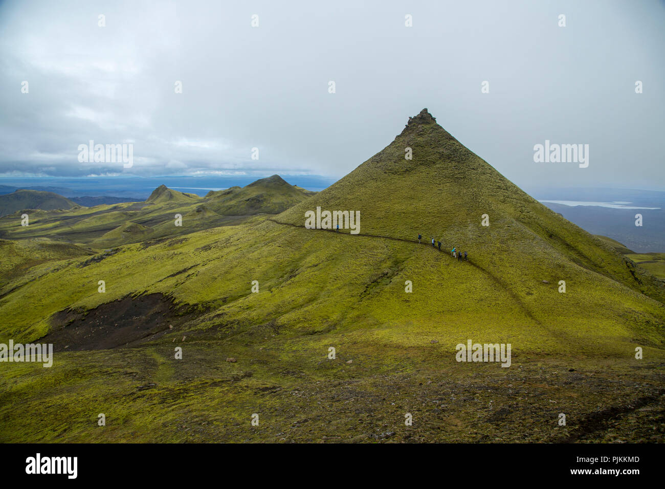 Island, Wanderer, grüne Vulkan Kegel, spitz, bizarr, bewölkter Himmel Stockfoto