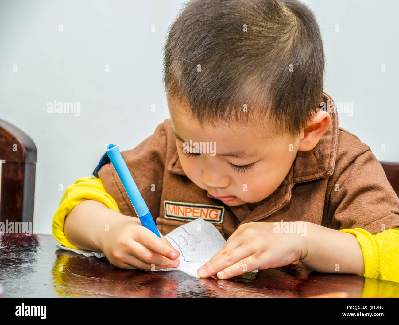 Junge chinesische Toddler kritzeln, mit einem Stift. Stockfoto