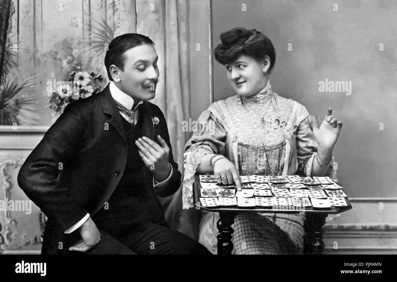 Flirten, Frau flirtet mit Mann, mit Karten, 1900s, Deutschland Stockfoto