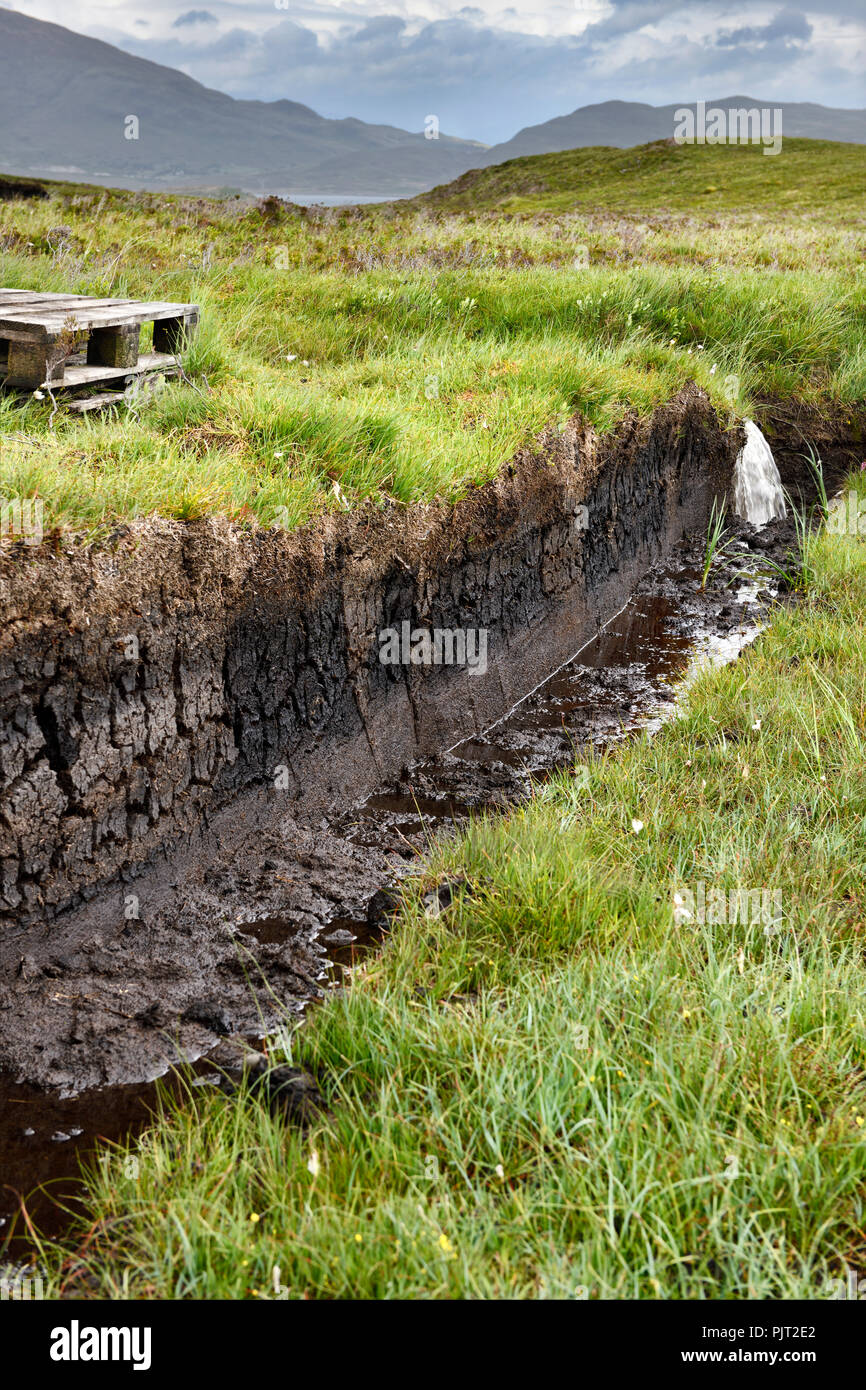 Trench cut in tiefe Torf der Moore in der Nähe von Feuchtgebieten Drinan auf der Isle of Skye Schottland mit Loch Slap Wasser für Ernte zu entleeren Stockfoto