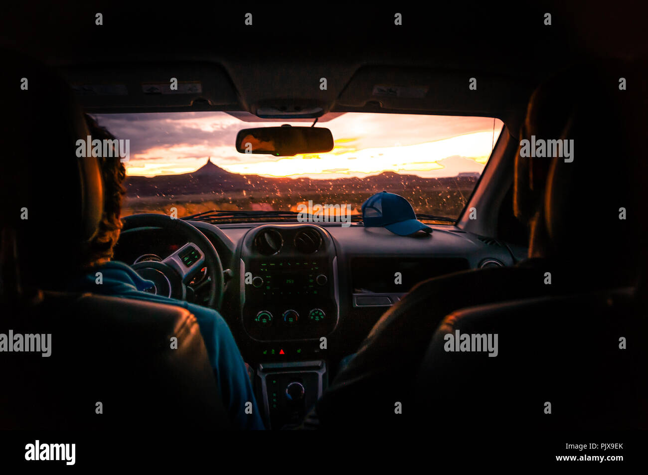 Fahrer und Freund im Auto beobachten, Sonnenuntergang, Indian Creek, Moab, Utah, USA Stockfoto