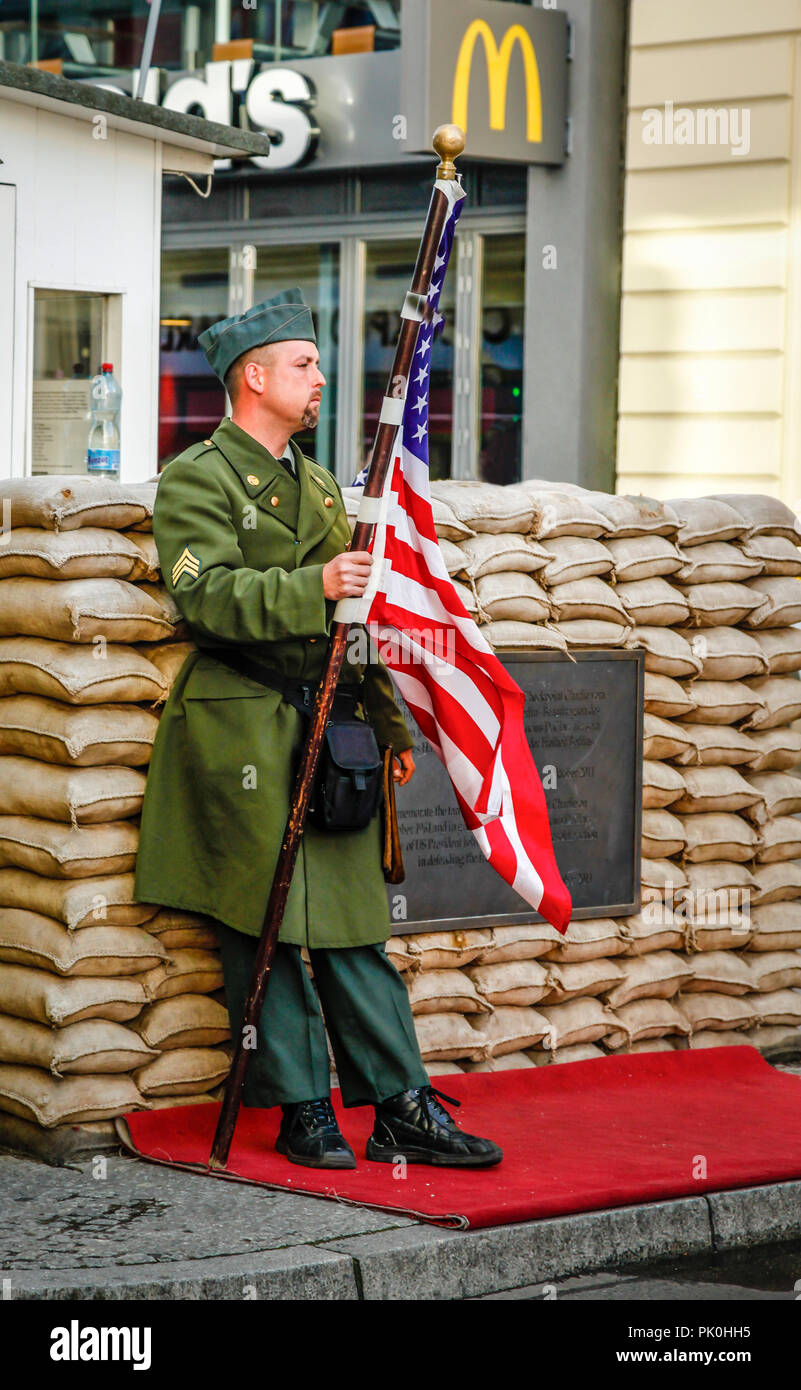 Leistungen für Touristen gehören Re-enactment des Menschen als ein US-Soldat am Checkpoint Charlie an der Friedrichstraße in Berlin, Deutschland gekleidet Stockfoto