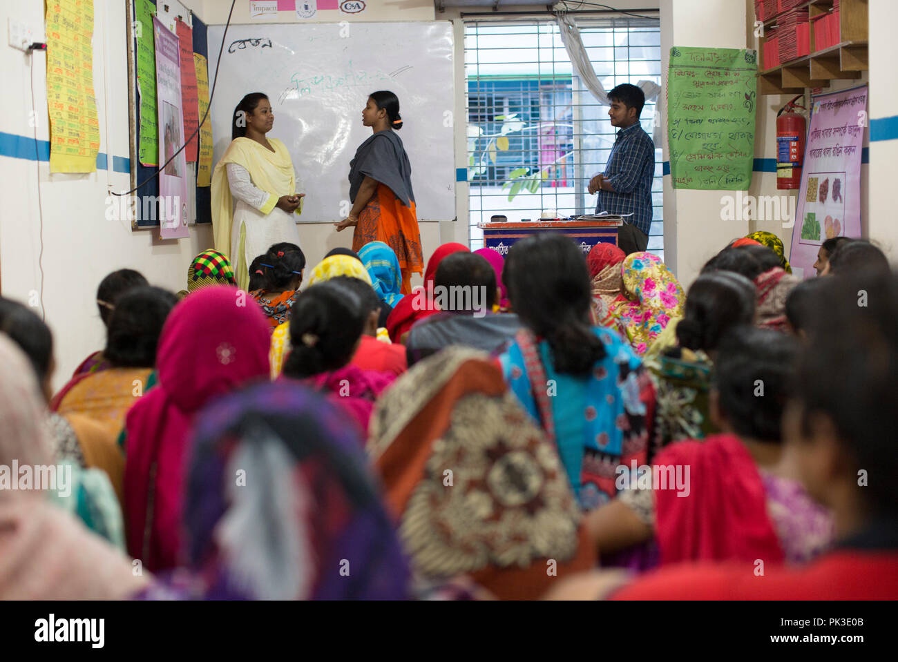 Eine Lehrerin führt einen Workshop für Textilarbeiterinnen in Dhaka, Bangladesh Stockfoto