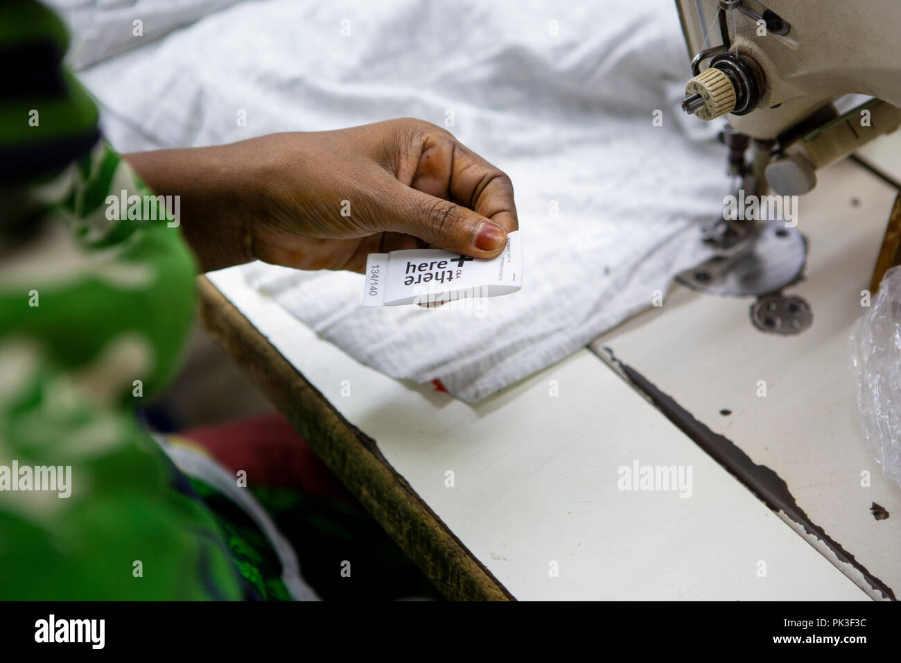 Ein Etikett in ein T-Shirt in einer Textilfabrik in Bangladesch genäht. Stockfoto