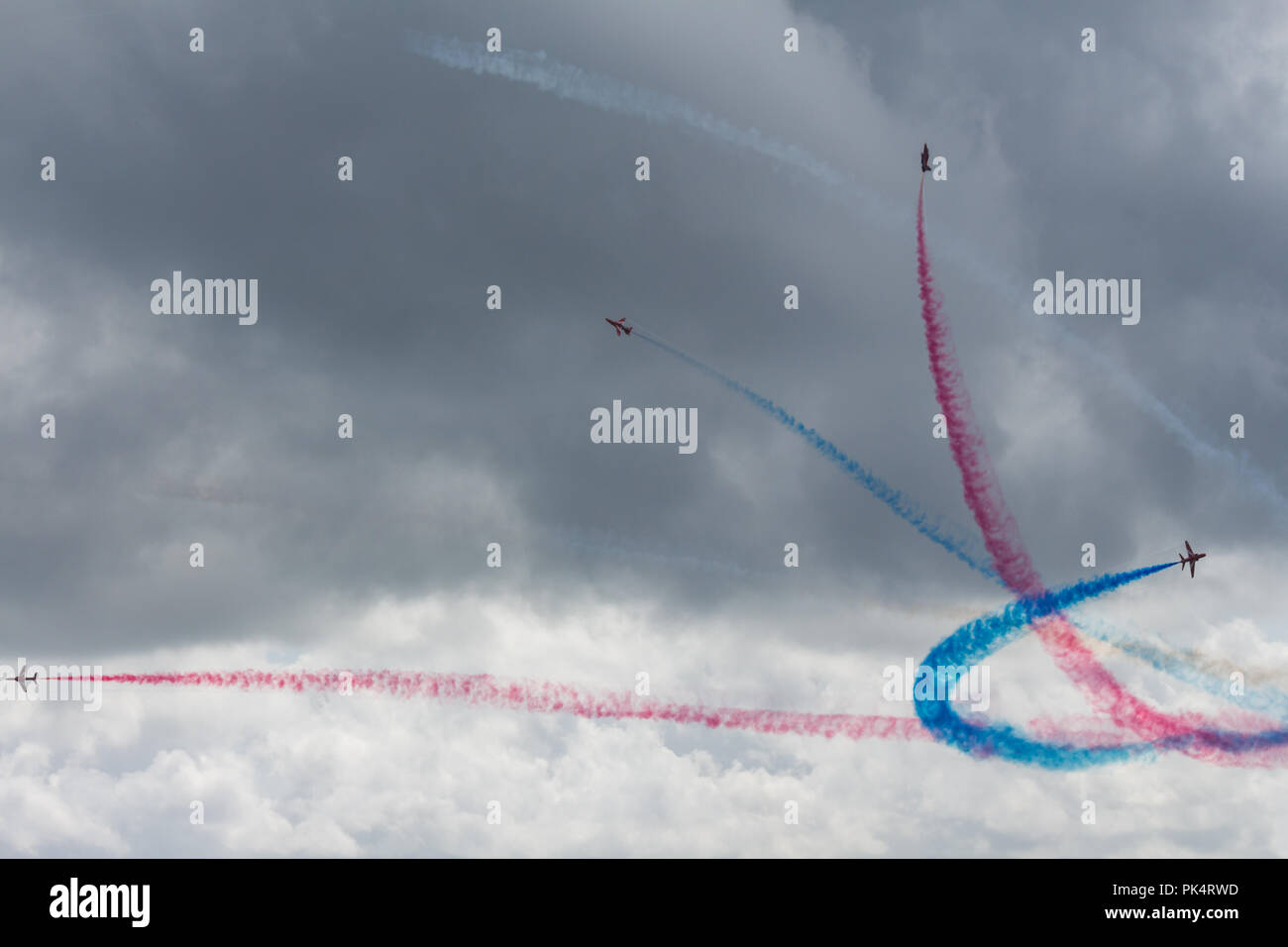 Pause Bildung - die roten Pfeile, die Royal Air Force Kunstflug Team, auf der Airshow über Carrickfergus Castle, County Antrim, Nordirland. Stockfoto