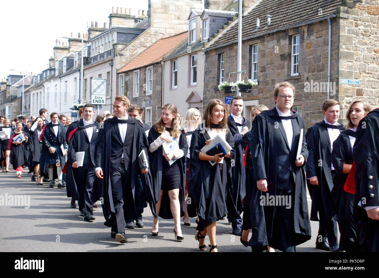 St Andrews University Absolventen auf ihre akademischen Prozession entlang der Straße in Richtung St. Salvator Quad ihre Gäste zu erfüllen Stockfoto