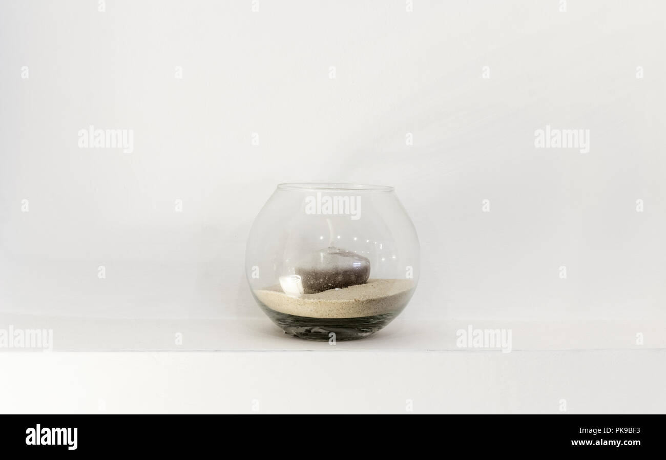 Glas Vase mit einer Kerze, weiße Wand Stockfoto