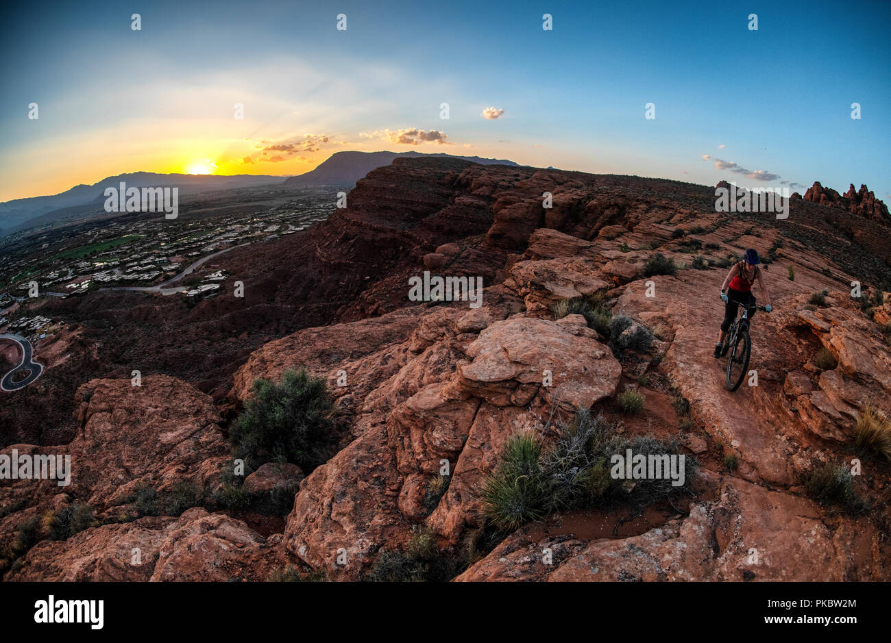 Eine Frau reitet ein Mountainbike auf der Paradies Rim Trail an der Chuckwalla trail Netzwerk in die roten Felsen der Wüste finden in der Nähe von Saint George, Utah, USA. Stockfoto