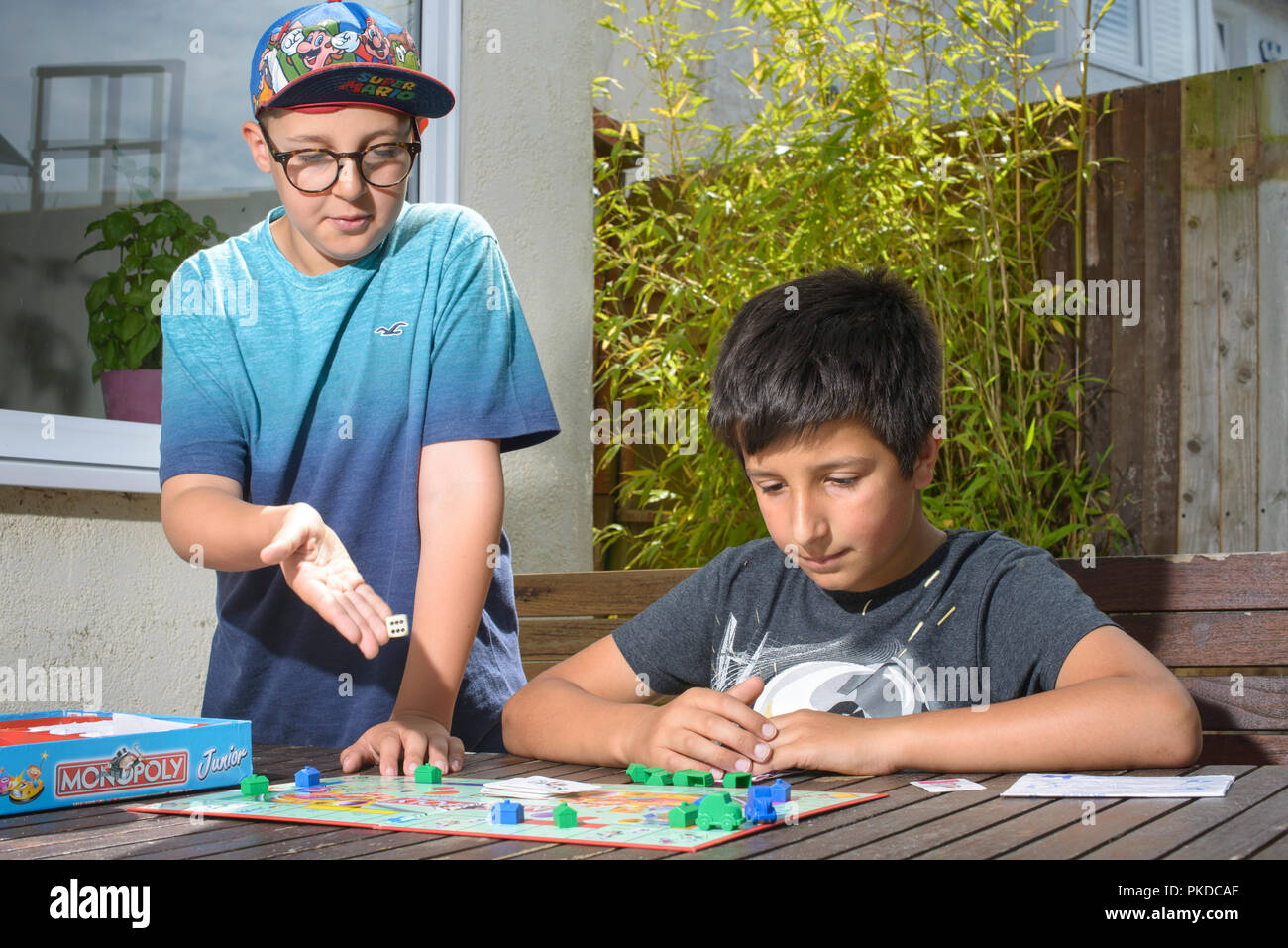 Jungen Jungen, 10 Jahre alt, spielen monopoly brettspiel, Großbritannien Stockfoto