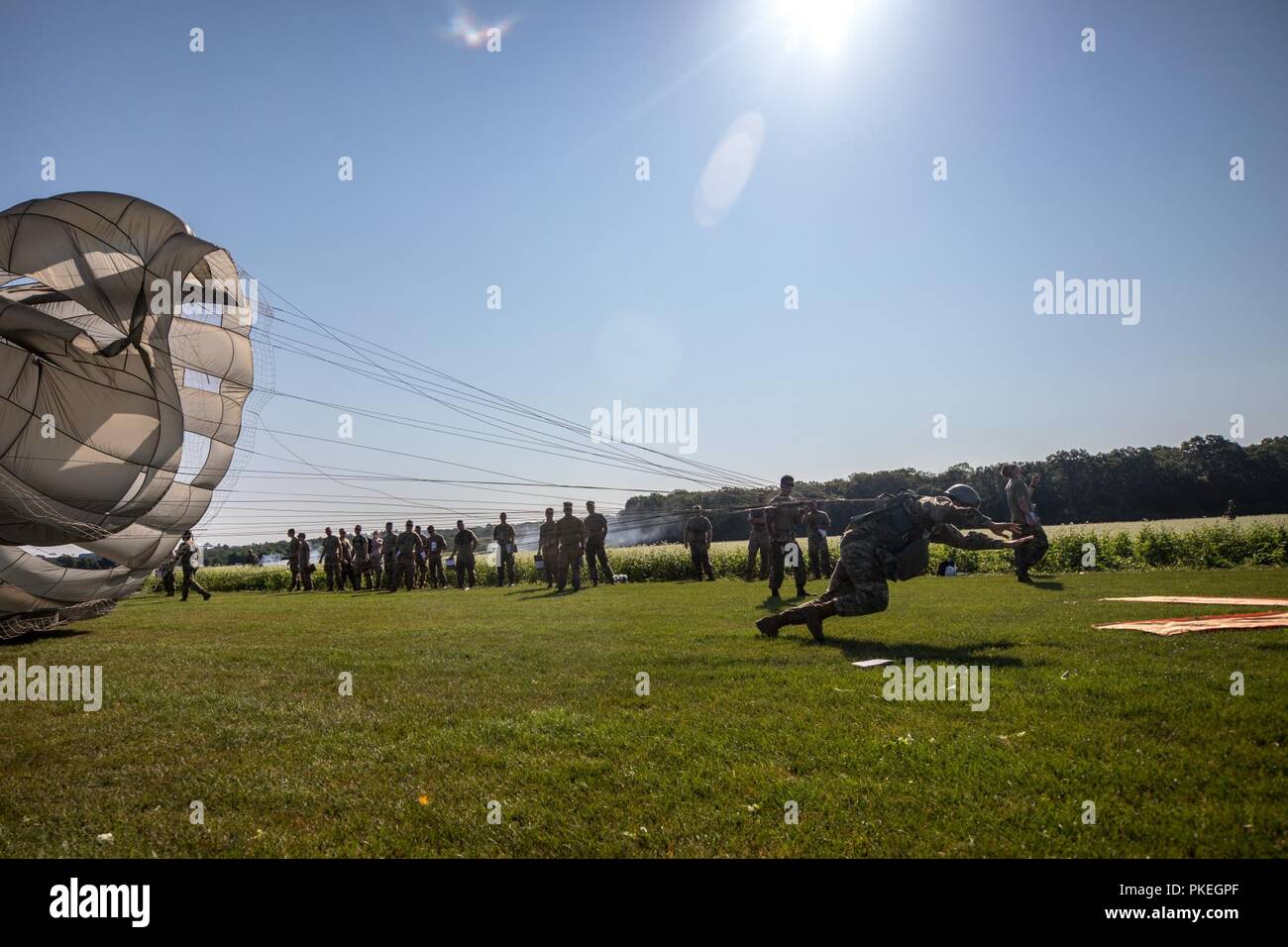 Die US-Armee Fallschirmjäger erreicht für die 'X' auf Schloss Drop Zone bei Leapfest an der Universität von Rhode Island, West Kingston, R.I., Aug 5, 2018. Leapfest ist der größte und am längsten bestehende, internationale statische Linie Fallschirm Training und Wettbewerb veranstaltet vom 56. Truppe den Befehl, Rhode-Island Army National Guard hohen Niveau zu fördern technische und Korpsgeist innerhalb der internationalen Gemeinschaft in der Luft. Stockfoto