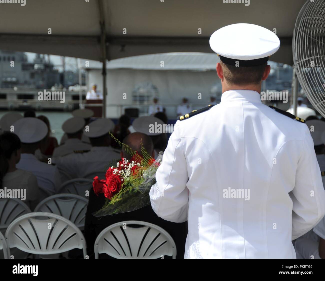 NORFOLK, Virginia (Aug. 1, 2018) ein Navy Officer halten Blumen, während das U-Boot Squadron 6 Ändern des Befehls an Bord der Virginia zu einem Familienmitglied vorgestellt werden - Klasse Angriffs-U-Boot USS Washington (SSN787) in Norfolk, Virginia. Kapitän Martin Muckian entlastet Kapitän Carl Hartsfield als Kommandant, Submarine Squadron Six. Stockfoto