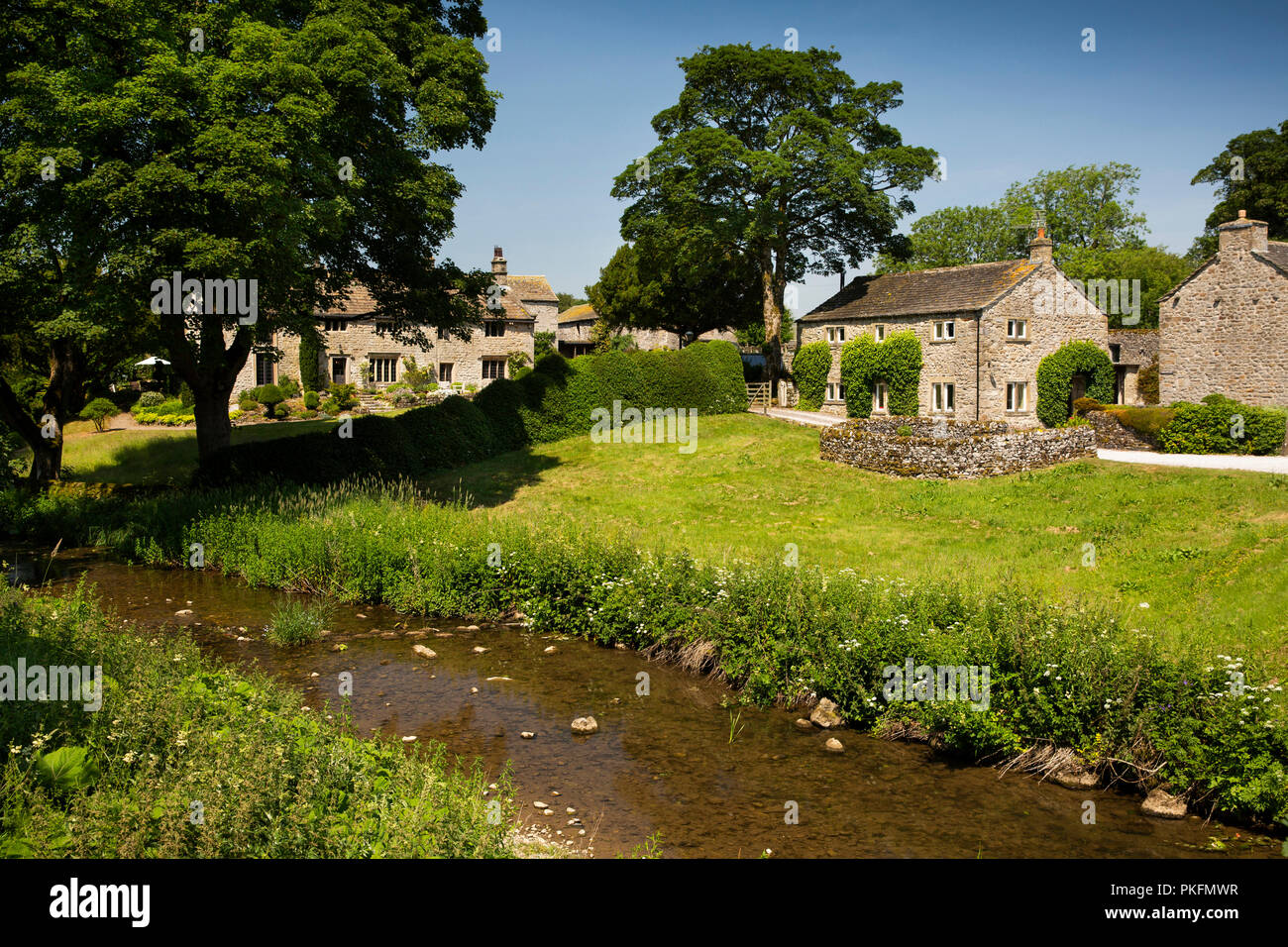England, Yorkshire, Wharfedale, Linton im Craven, aus Stein gebaute Eigenschaften neben Linton Beck Stockfoto