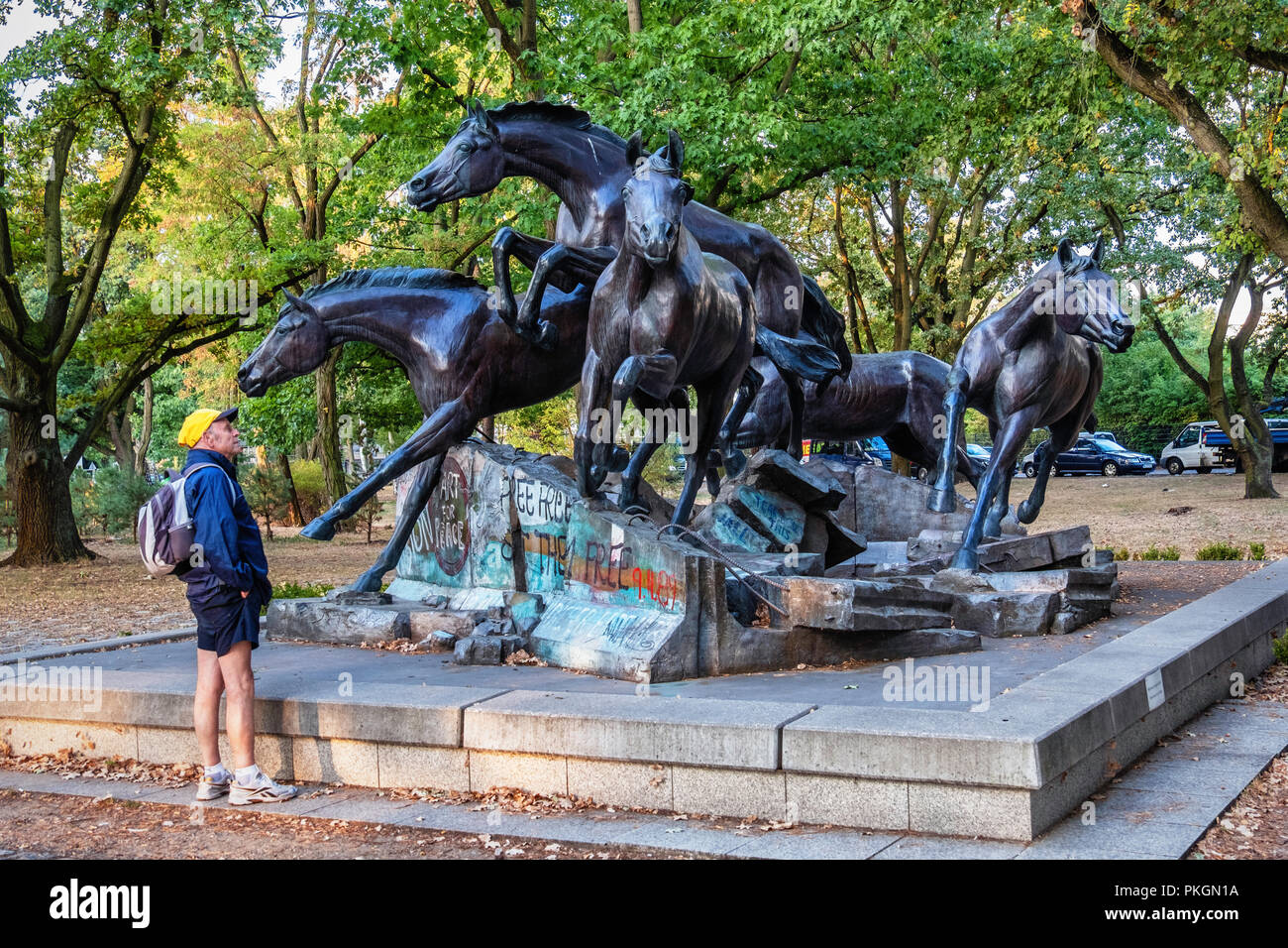 Berlin, Dahlem. Bronze Skulptur von Fünf wilde Pferde über Reste der Berliner Mauer springen. Geschenk aus den USA in die FDR erinnert an den Tag, an dem die Mauer fiel. Stockfoto
