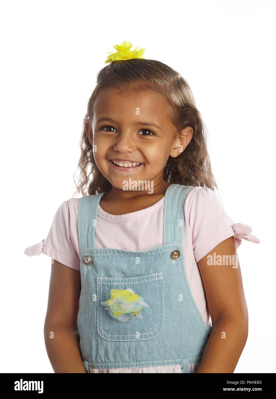 Kleines Mädchen in Overalls Stockfoto