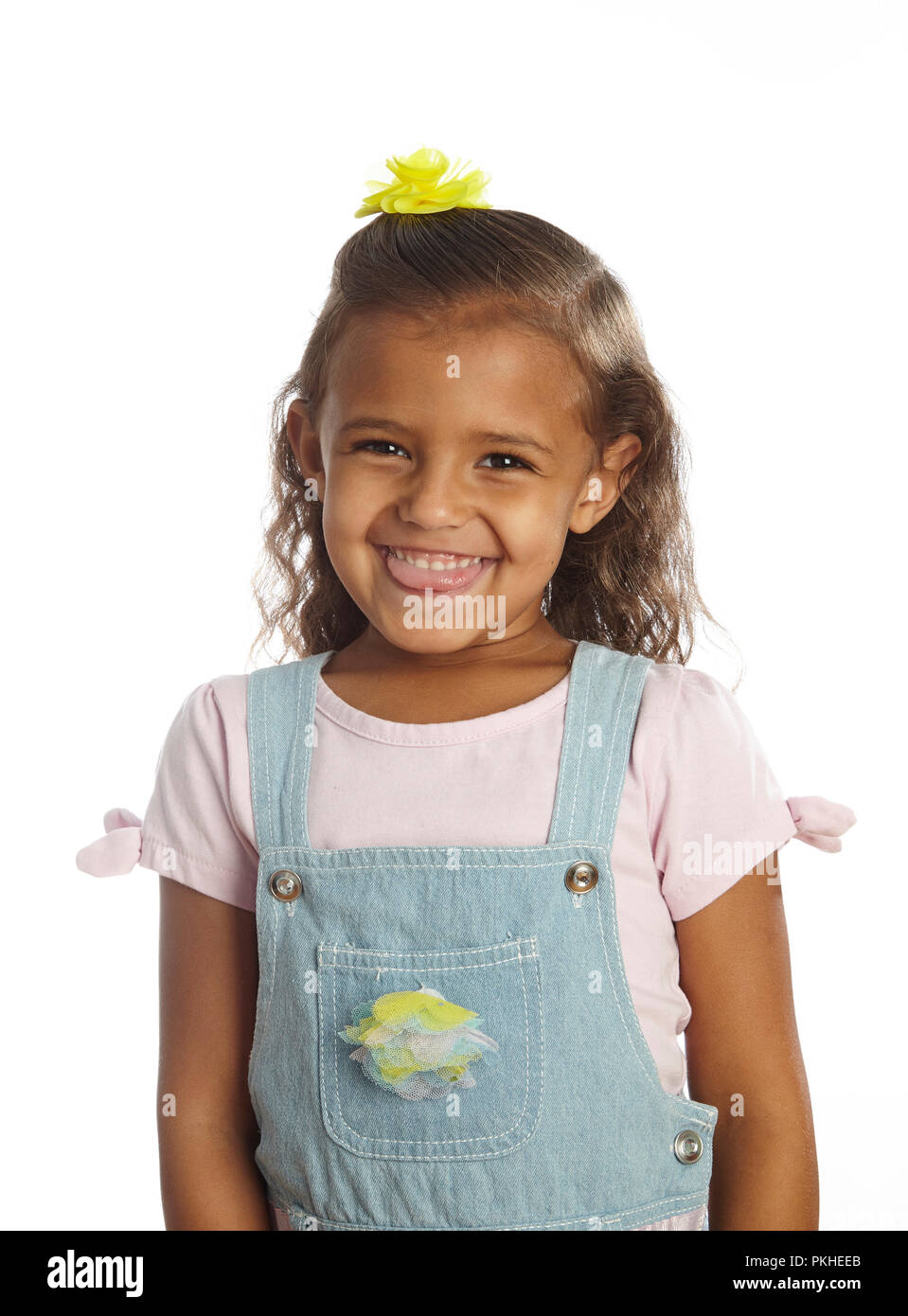 Kleines Mädchen in Overalls Stockfoto