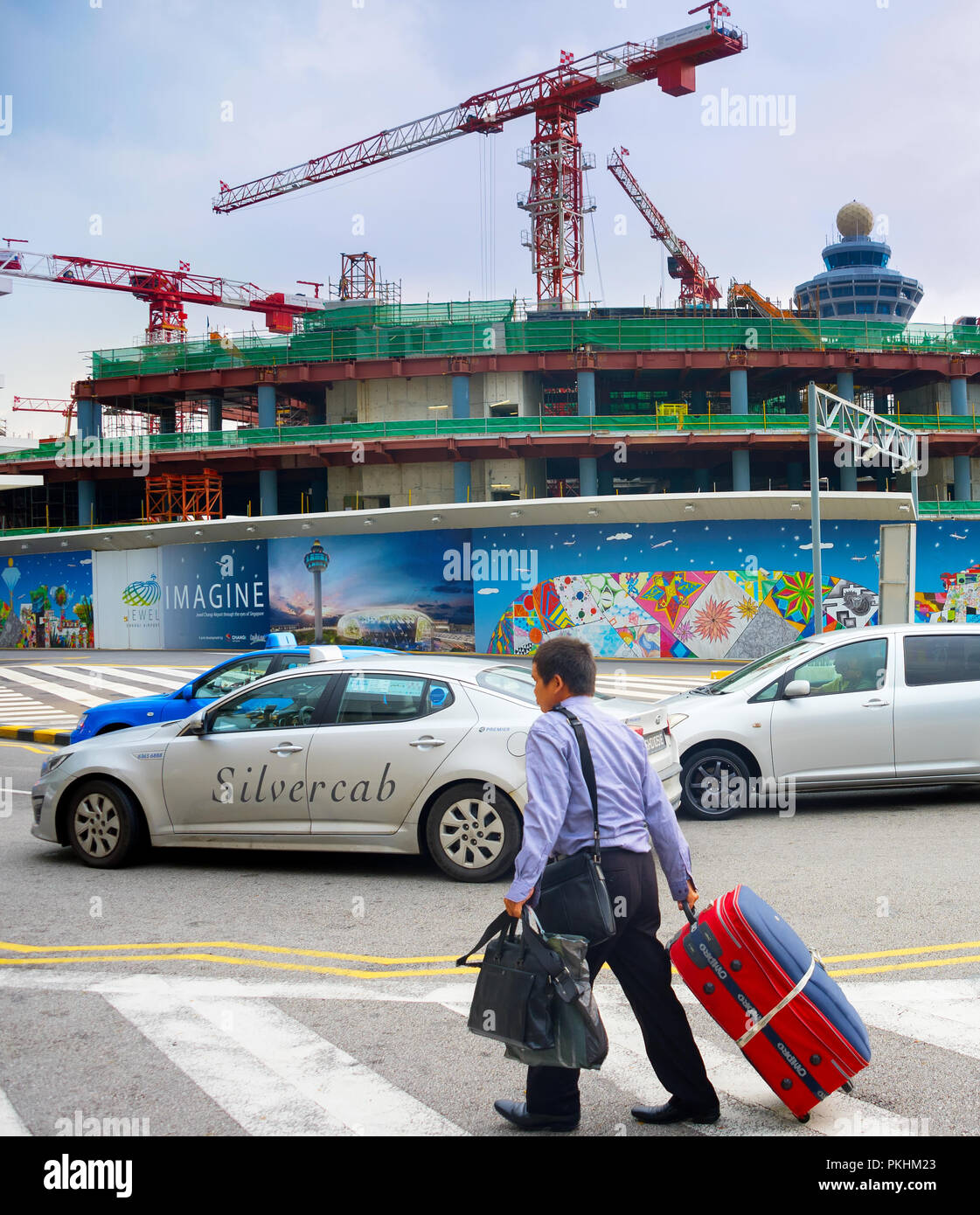 Singapur - Jan 13, 2017: Mann Tragetasche vor der Baustelle des Changi Airport Terminal. Changi Airport dient mehr als 100 Fluggesellschaften betr. Stockfoto